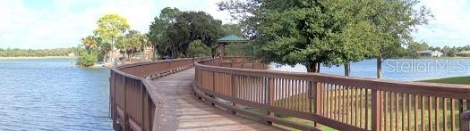 6552 Moorings Point Circle, Unit 102 Lakewood Ranch, FL 34202 - Photo 48 of 57 a view of a balcony with wooden fence