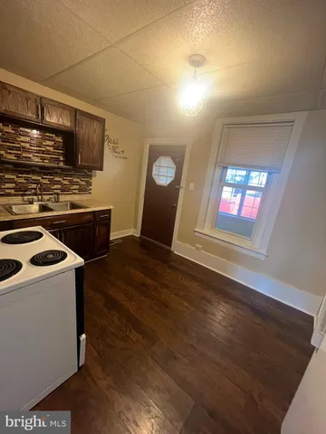 a kitchen that has a sink and a stove in it
