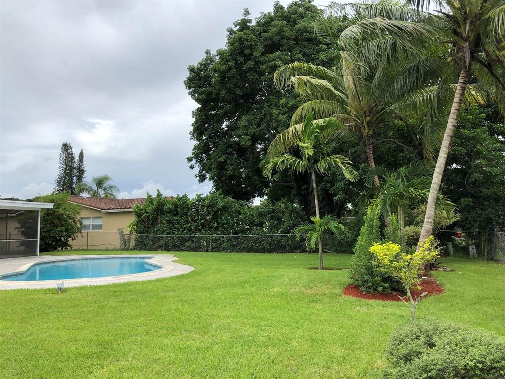 3980 Northwest 109th Avenue Coral Springs, FL 33065 - Photo 12 of 12 a view of a swimming pool with a garden