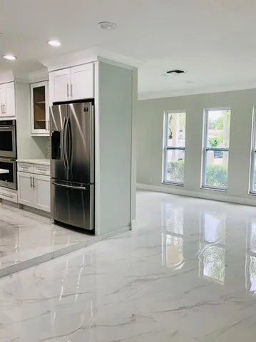 a kitchen with granite countertop a refrigerator and a sink