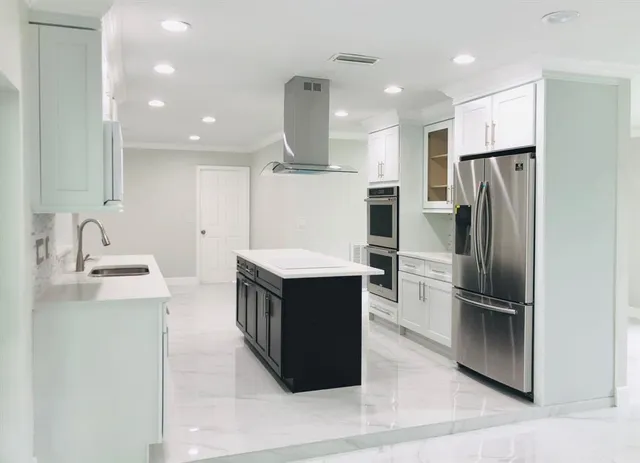a kitchen with stainless steel appliances a refrigerator and a sink