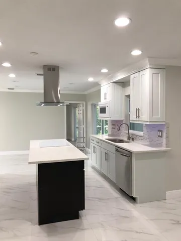 a kitchen with a sink dishwasher a stove and a refrigerator with wooden floor