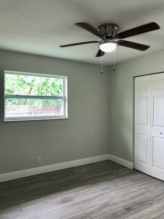 3980 Northwest 109th Avenue Coral Springs, FL 33065 - Photo 8 of 12 an empty room with wooden floor fan and windows