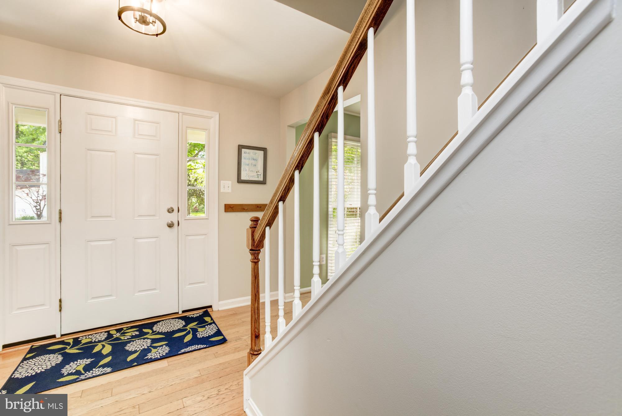 326 Riding Ridge Road Annapolis, MD 21403 - Photo 4 of 63 a view of a hallway with wooden floor and staircase