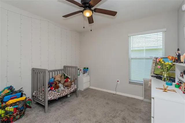 a children room with toys and a chandelier