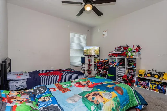 a bedroom with a bed and a dresser in it