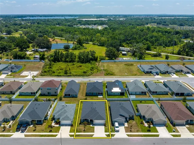 an aerial view of residential houses with outdoor space and swimming pool