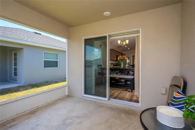 a living room with a table chair and a pool