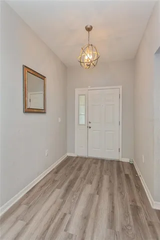 a view of a room with wooden floor and a hallway
