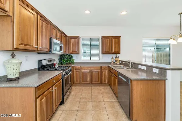 a kitchen with a sink stove top oven and cabinets