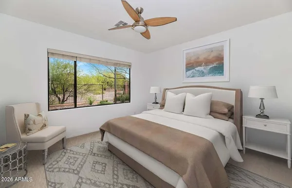 a bedroom with a large bed and a window