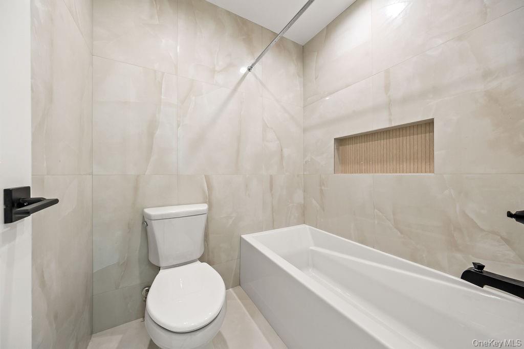 62 Blauvelt Road, Unit 202 Monsey, NY 10952 - Photo 24 of 34 a white toilet sitting next to a bath tub