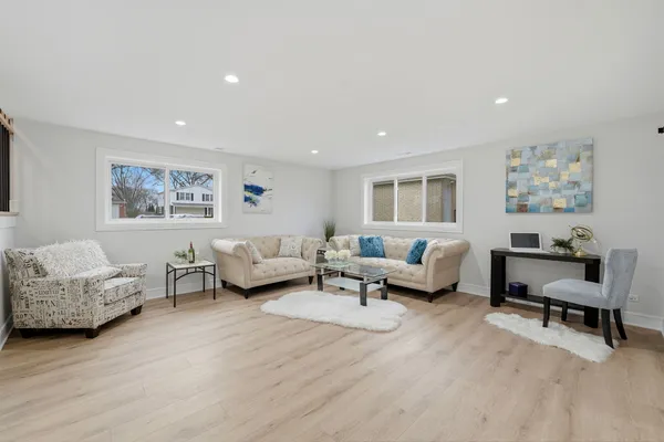 a living room with furniture and a potted plant on table