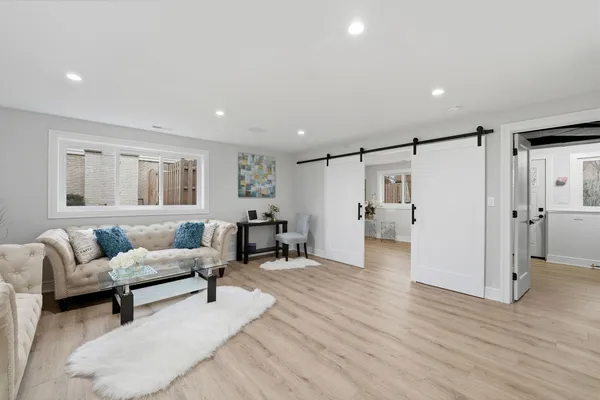 a living room with furniture and a wooden floor