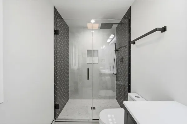 a bathroom with a shower toilet and sink