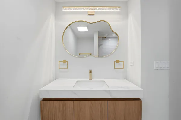 a bathroom with a sink and mirror