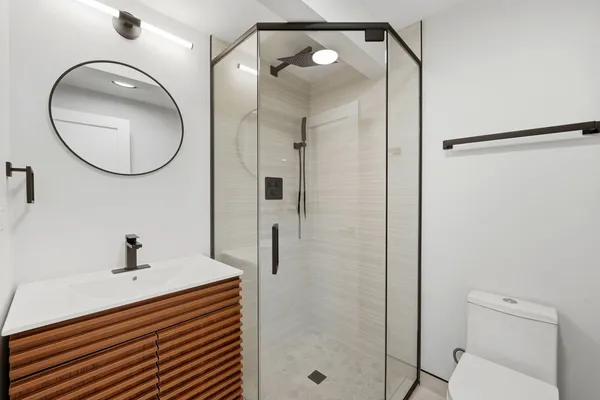 a bathroom with a sink a mirror and a shower