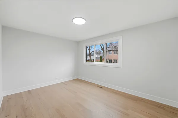 a view of a room with window and wooden floor