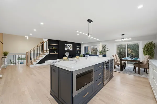 a kitchen with a stove and chairs