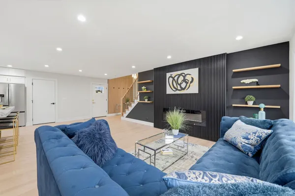 a living room with furniture and wooden floor