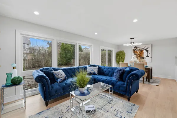 a living room with furniture ceiling fan and a rug