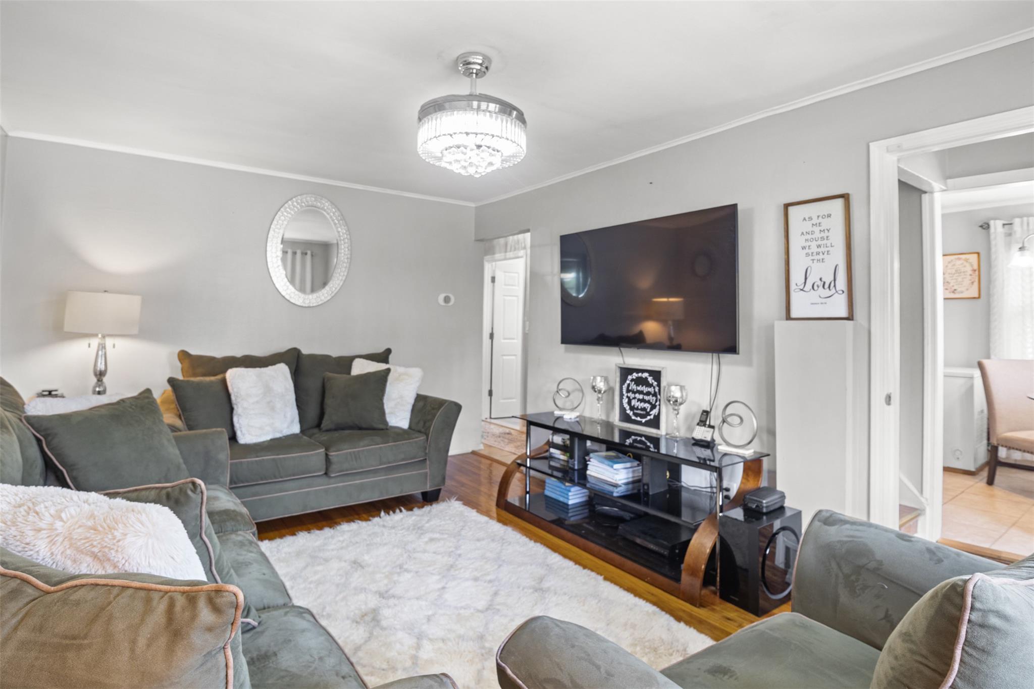 239-15 147th Road Queens, NY 11422 - Photo 13 of 27 a living room with furniture and a flat screen tv