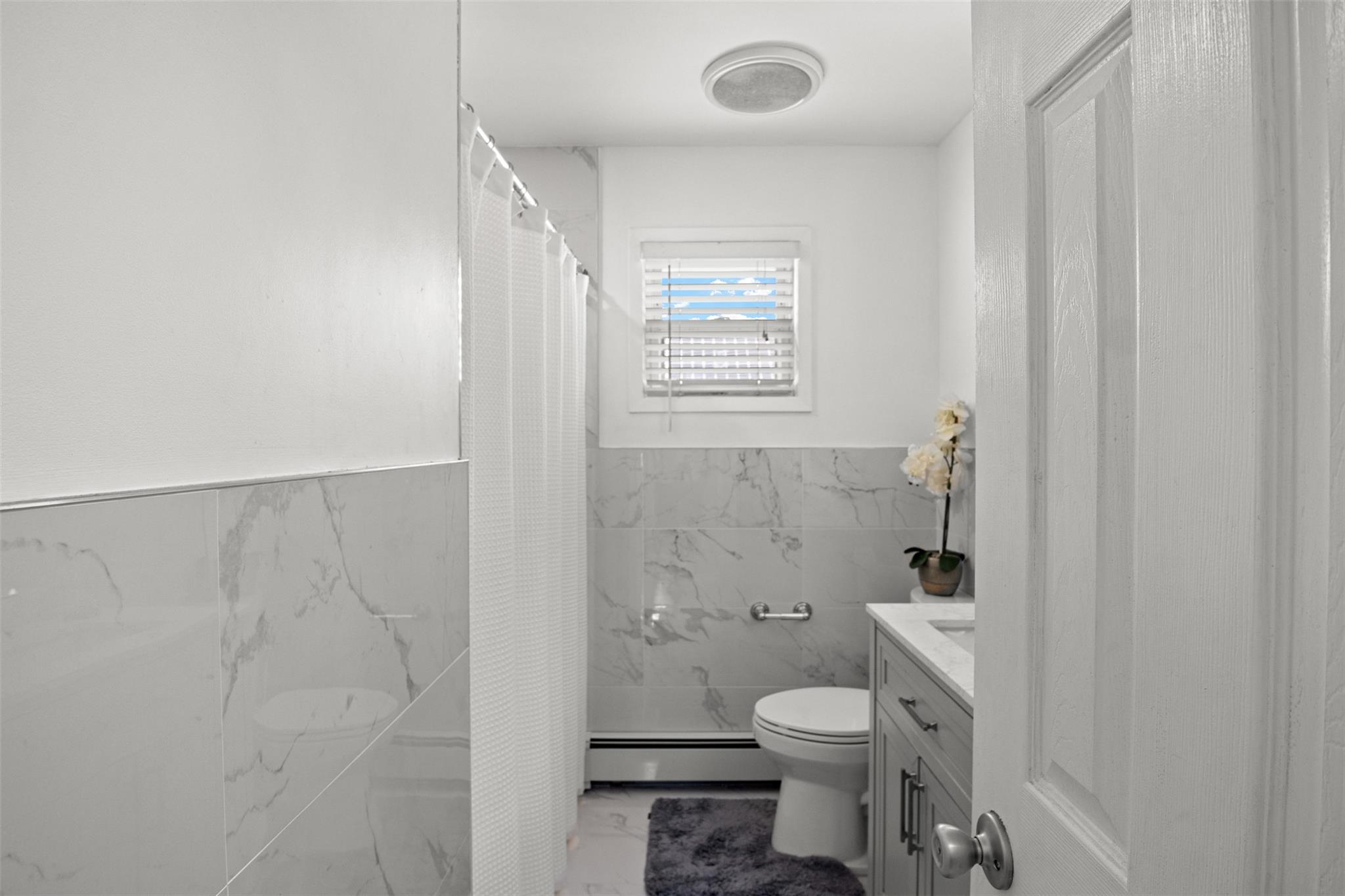 239-15 147th Road Queens, NY 11422 - Photo 16 of 27 a bathroom with a toilet a sink and a shower