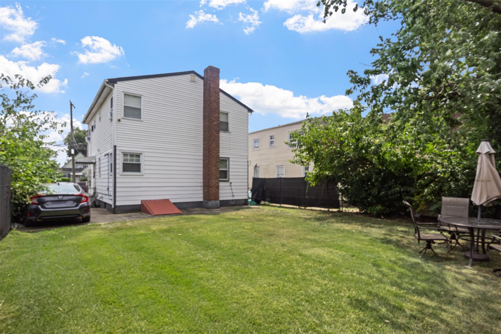 239-15 147th Road Queens, NY 11422 - Photo 22 of 27 a view of a backyard with sitting area