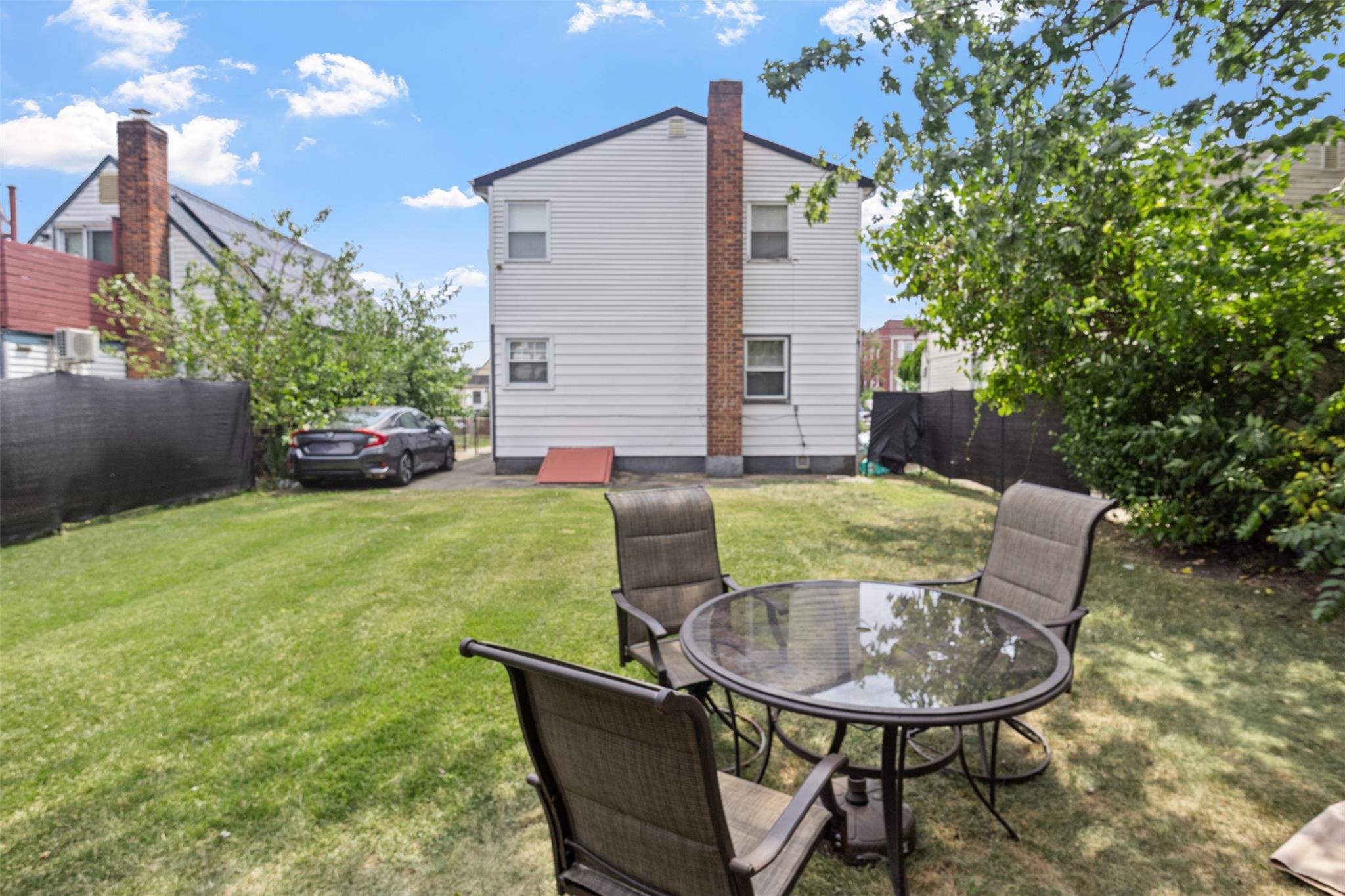 239-15 147th Road Queens, NY 11422 - Photo 23 of 27 a view of backyard of house with seating space