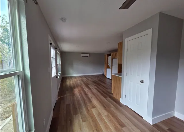 a view of hallway with wooden floor and stairs