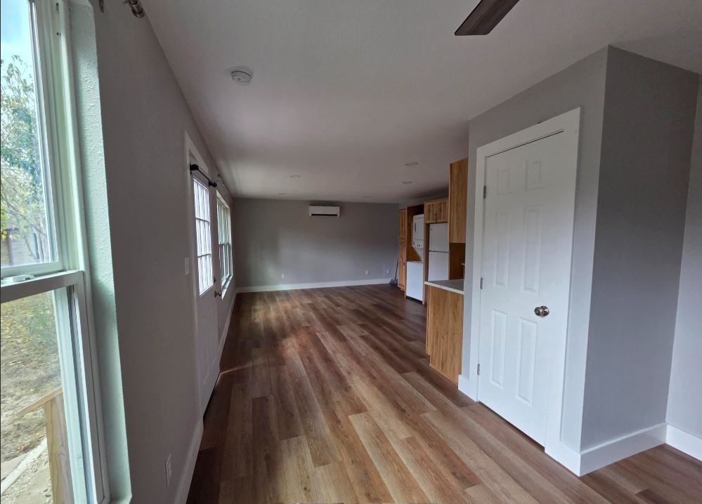 505 East Lane Kerrville, TX 78028 - Photo 3 of 10 a view of hallway with wooden floor and stairs