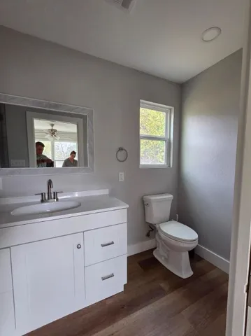 a bathroom with a toilet sink and mirror