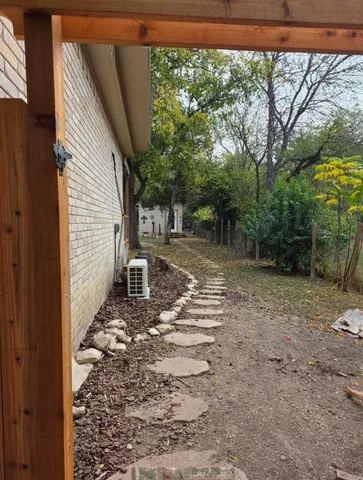 a view of a yard with large trees