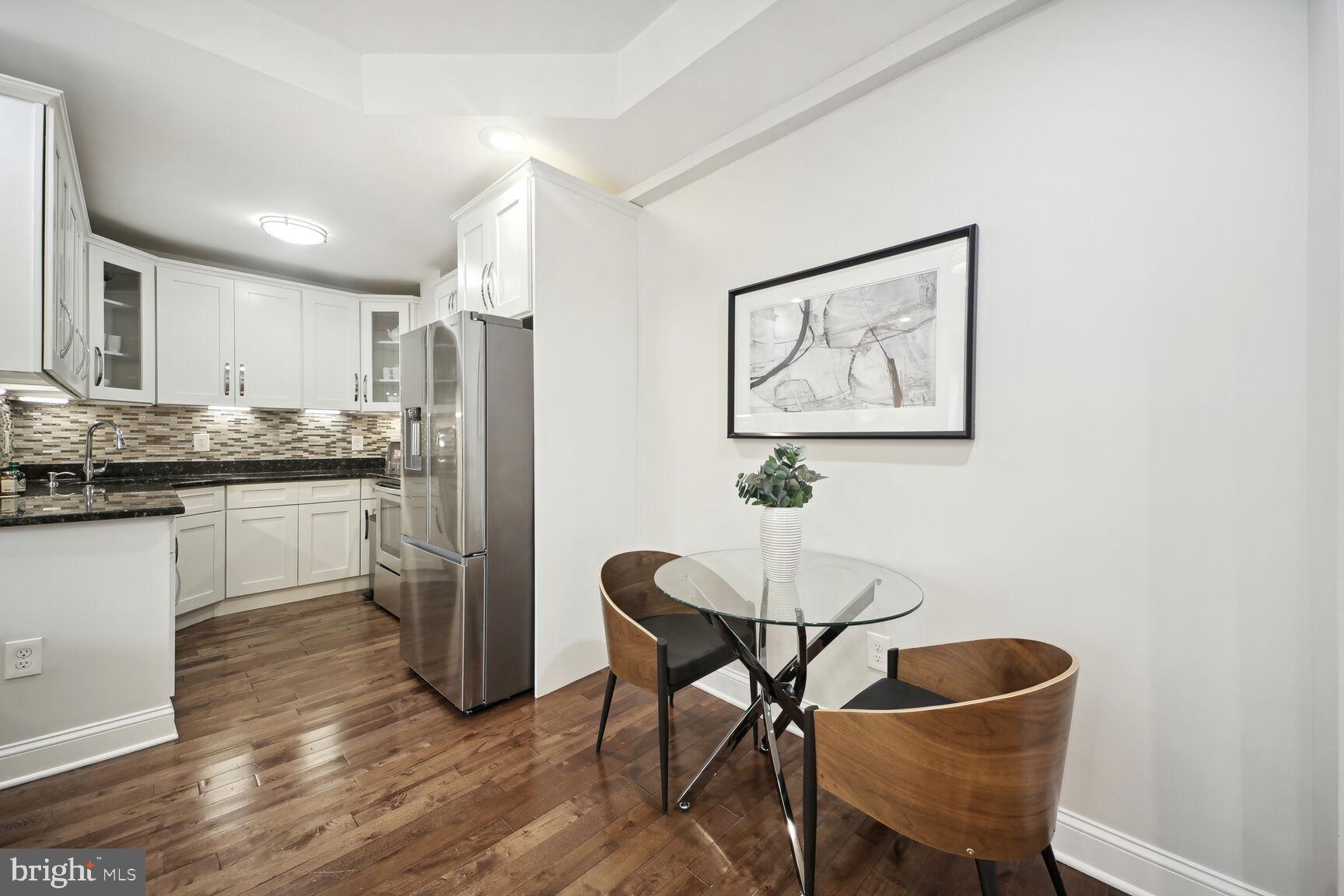 1451 Park Road Northwest, Unit 113 Washington, DC 20010 - Photo 16 of 50 a kitchen with a table and chairs