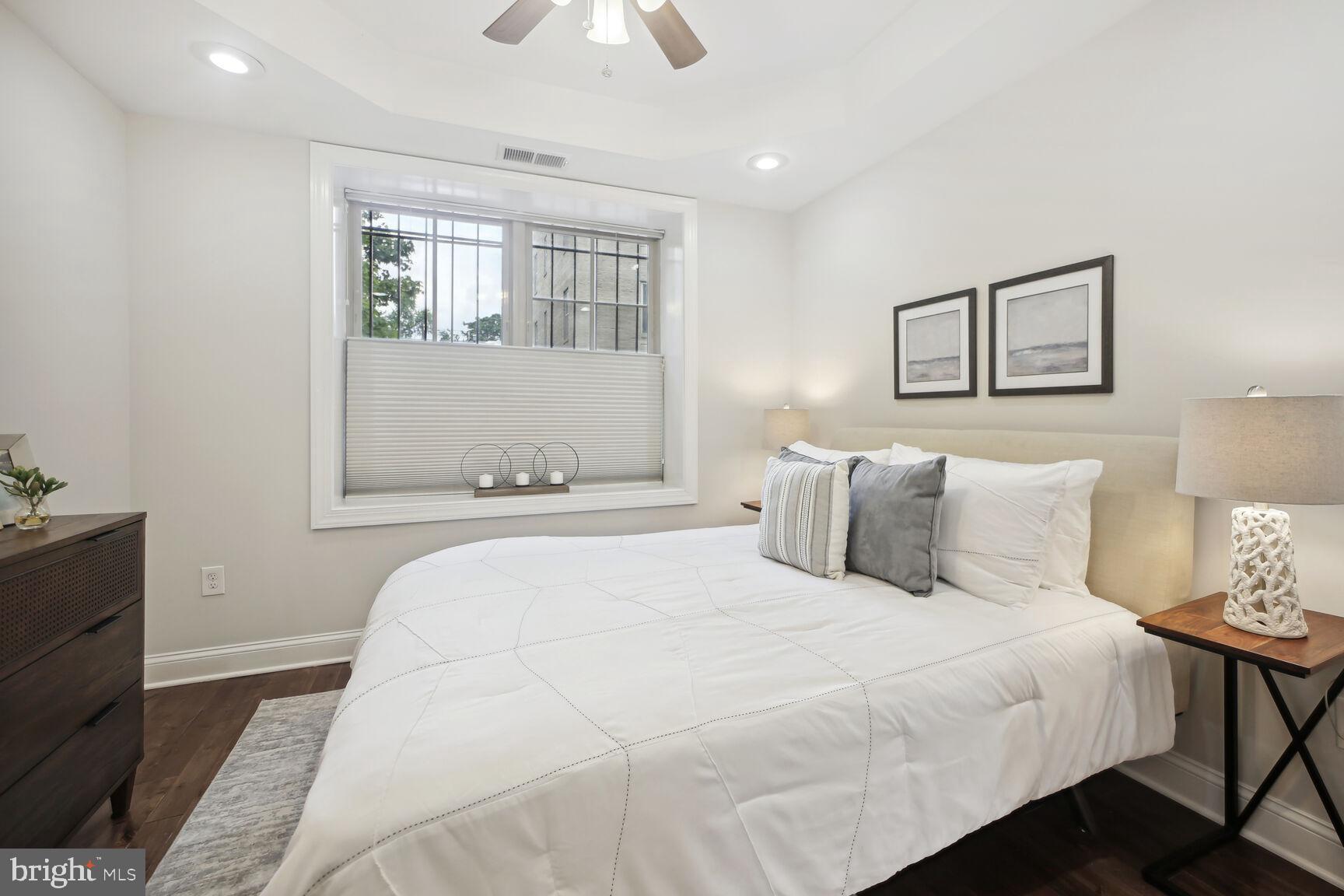1451 Park Road Northwest, Unit 113 Washington, DC 20010 - Photo 21 of 50 a bedroom with a large bed and a window