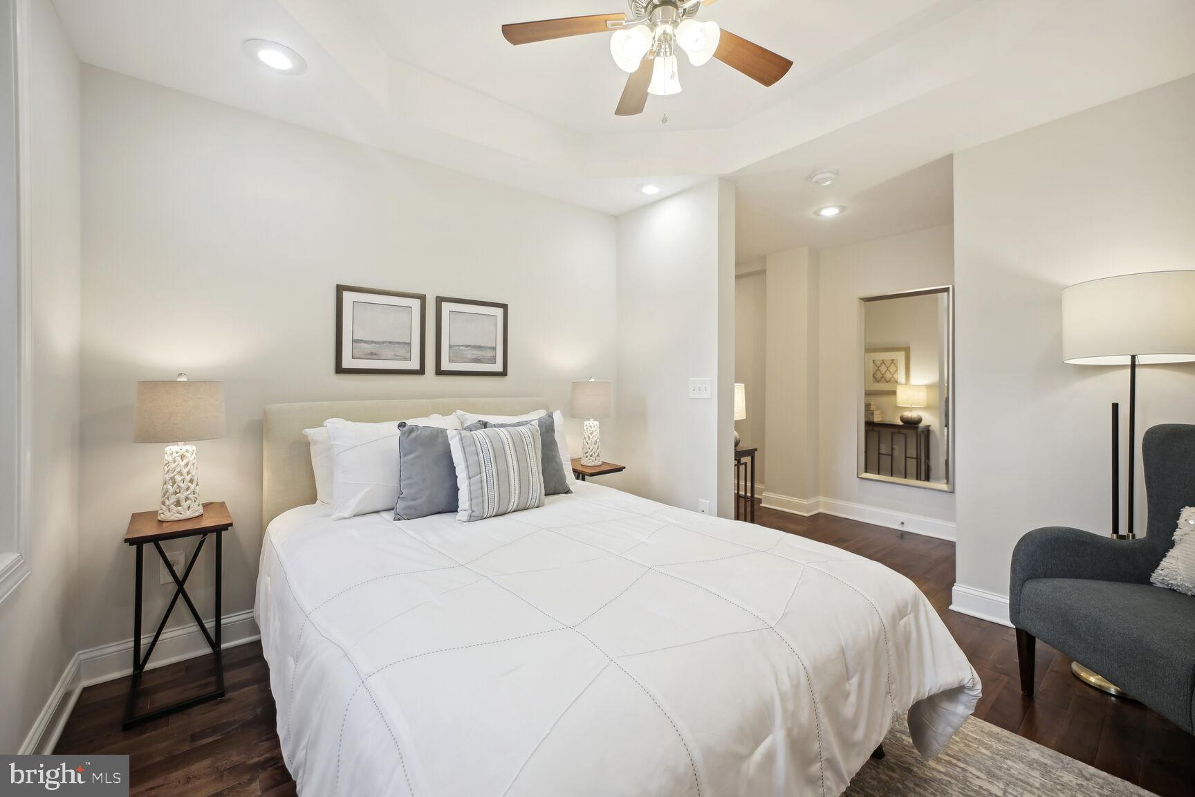 1451 Park Road Northwest, Unit 113 Washington, DC 20010 - Photo 24 of 50 a bedroom with a bed and a chandelier