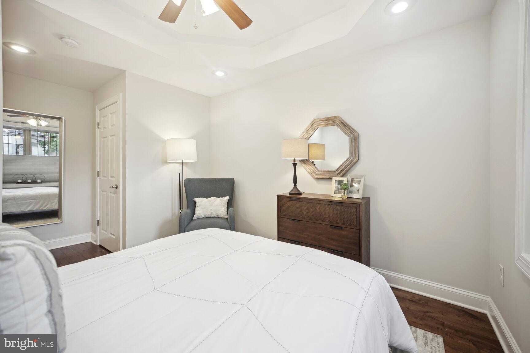1451 Park Road Northwest, Unit 113 Washington, DC 20010 - Photo 25 of 50 a bedroom with a bed and a chandelier