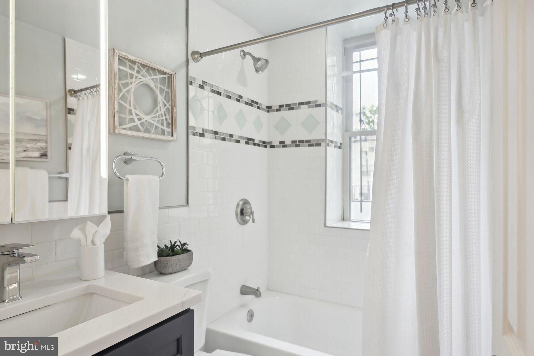 1451 Park Road Northwest, Unit 113 Washington, DC 20010 - Photo 32 of 50 a bathroom with a sink and a mirror