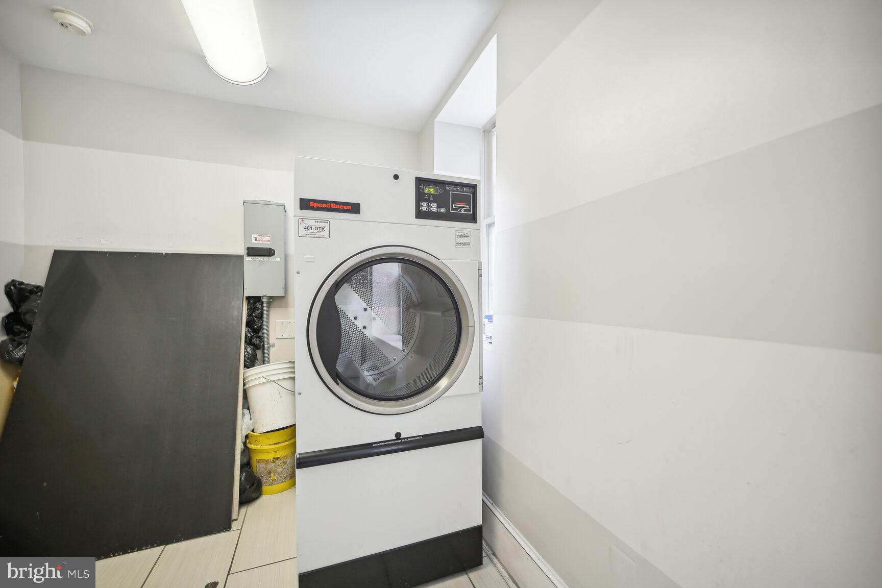1451 Park Road Northwest, Unit 113 Washington, DC 20010 - Photo 36 of 50 a utility room with dryer and washer