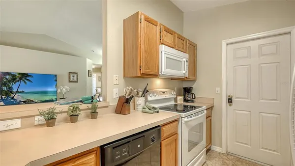 a kitchen with sink cabinets and microwave