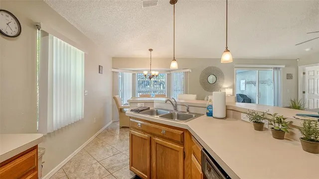 a kitchen with a sink and a refrigerator