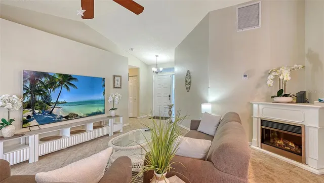 a living room with furniture a fireplace and a flat screen tv
