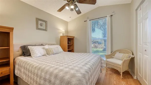 a bedroom with a bed and a chair