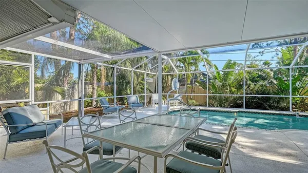 a swimming pool with outdoor seating and yard