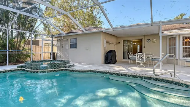 a view of a backyard with plants and a patio