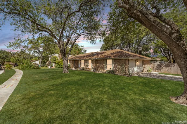 a yellow and red house with a garden
