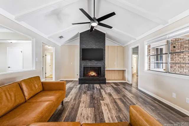 a living room with furniture and a fireplace
