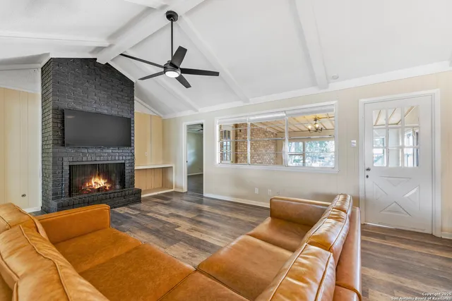 a living room with furniture or dining table and a fireplace