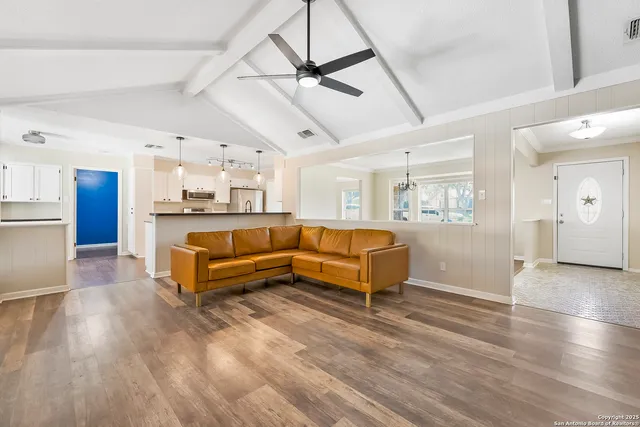 a living room with kitchen island furniture and a wooden floor