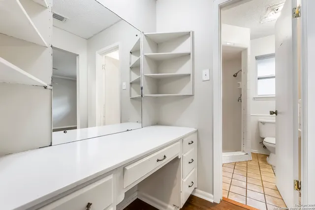 a view of walk in closet with empty racks